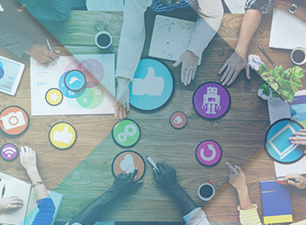 Aerial view graphic-styled image of social icons with hands reaching across table